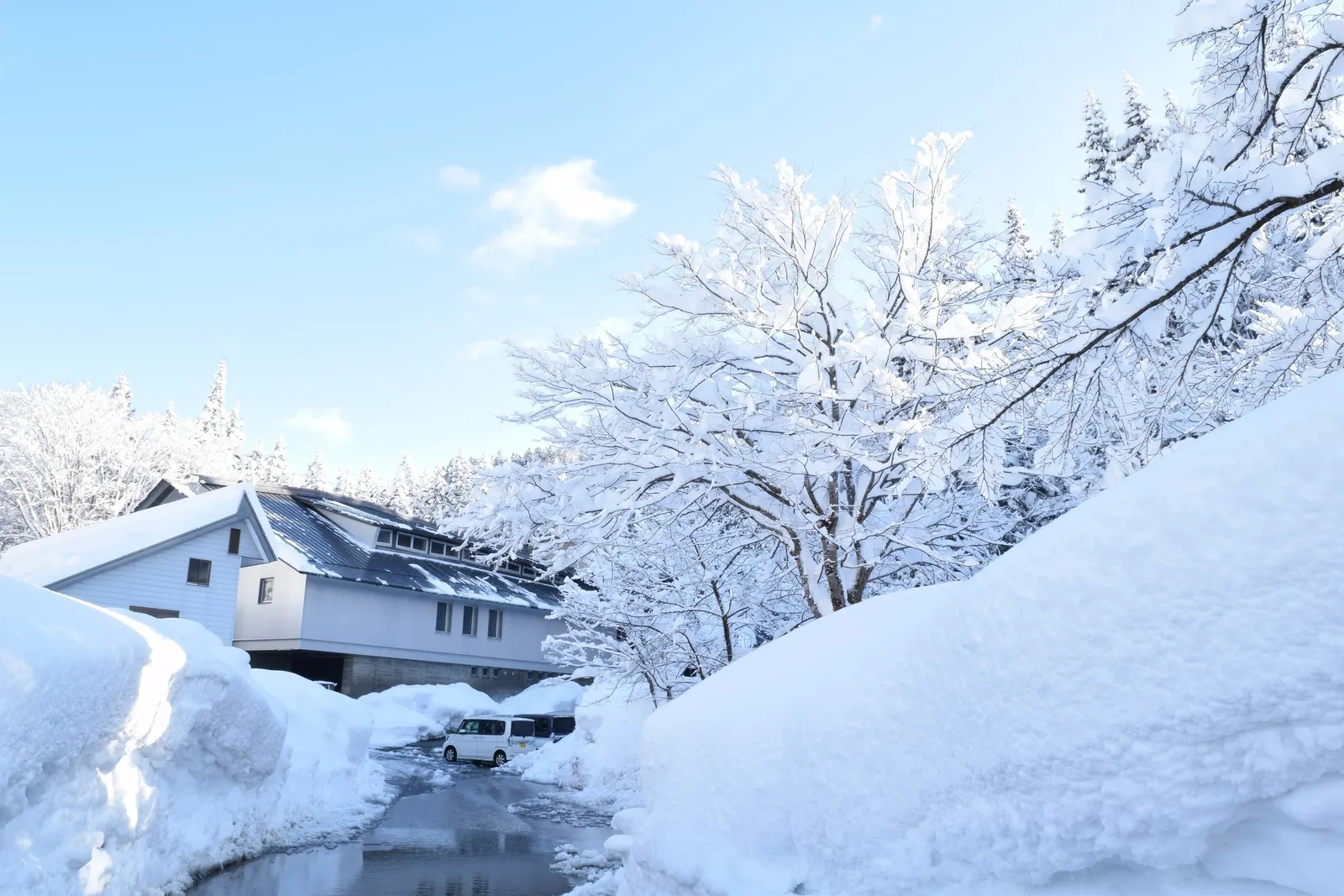 Tsunan Sake Brewery under deep snow and a clear winter sky in Tsunan, Niigata